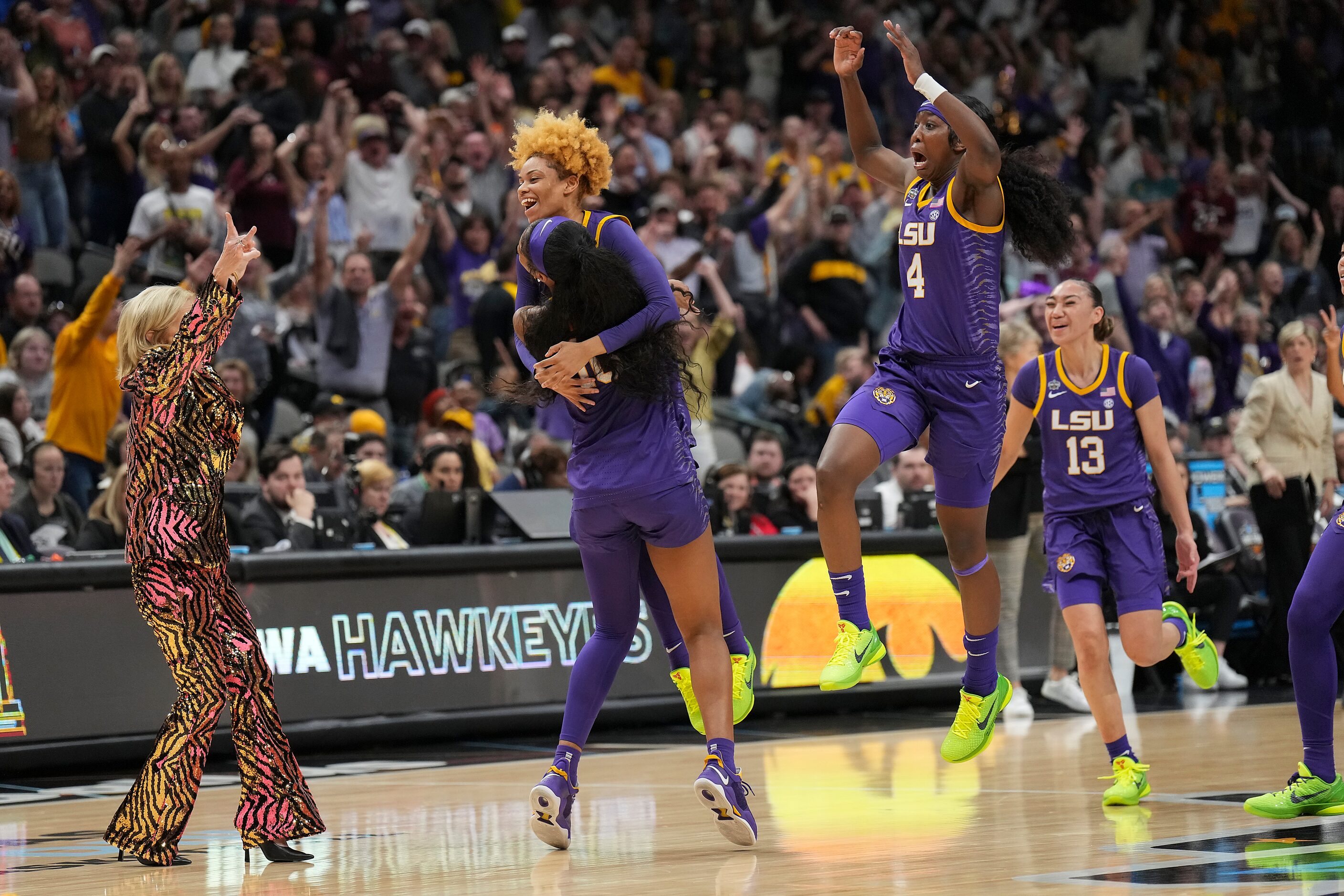 LSU guard Jasmine Carson (2) celebrates with forward Angel Reese (10) along with head coach...