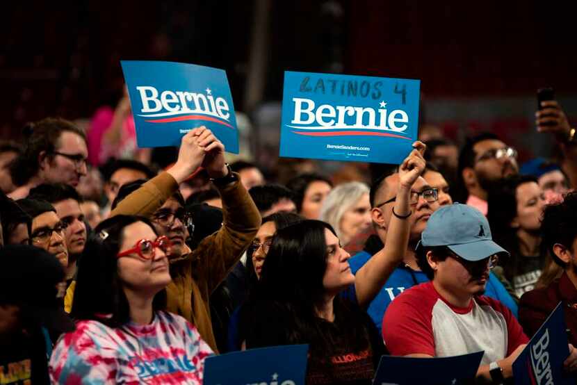 Supporters of Democratic presidential hopeful Bernie Sanders cheer during a rally at the...