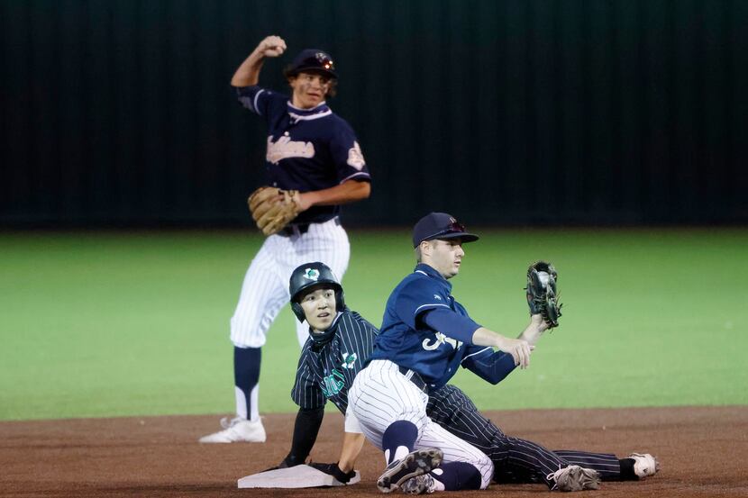 Southlake’s Max Reyes is called safe at second after an attempted tag by Keller’s Todd Baffa...