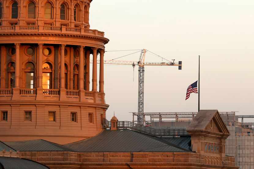 Construction cranes dot the landscape around the Texas State Capitol in Austin, Texas,...