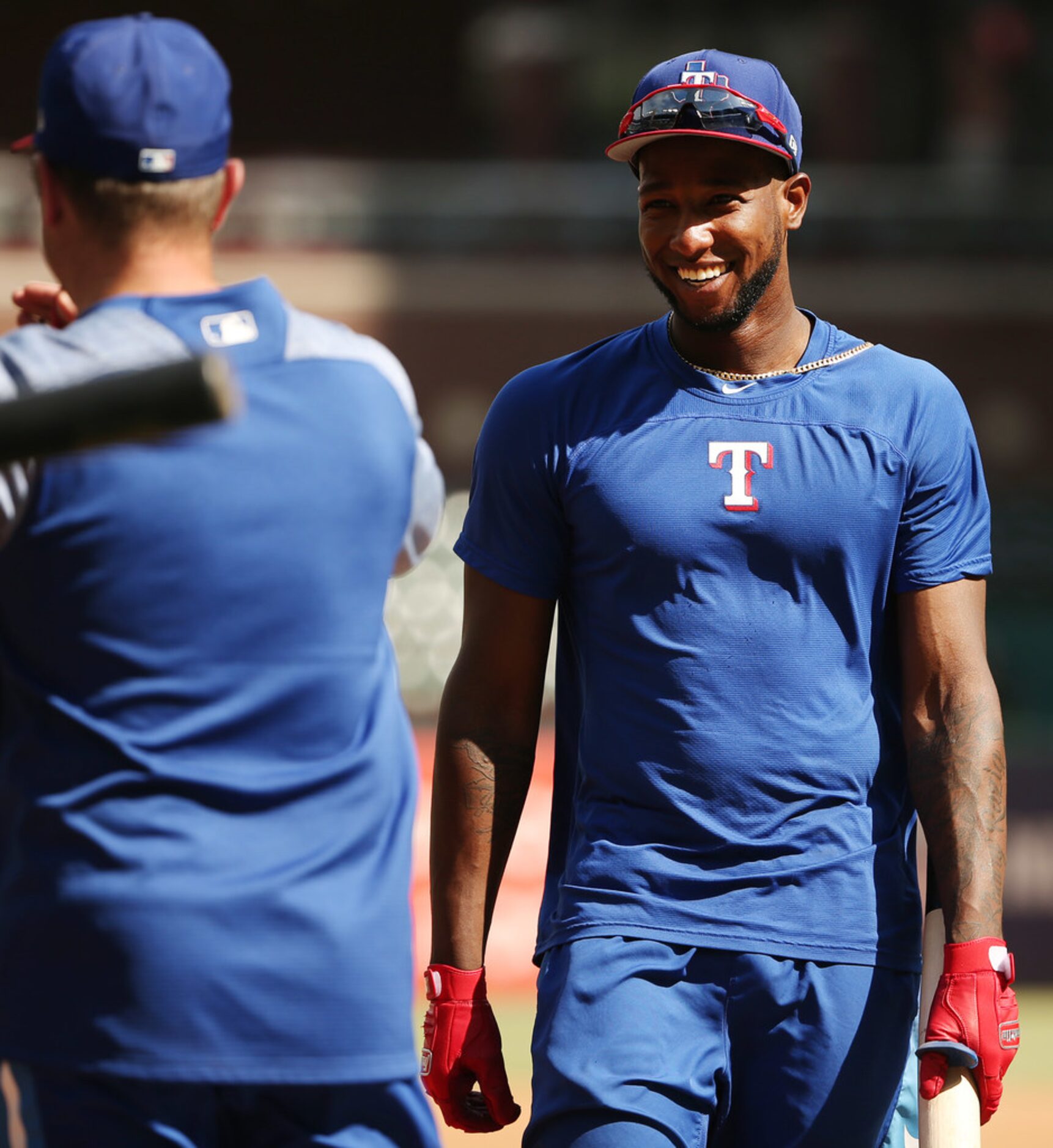 Texas Rangers shortstop Jurickson Profar (19) talks to a teammate during batting practice...