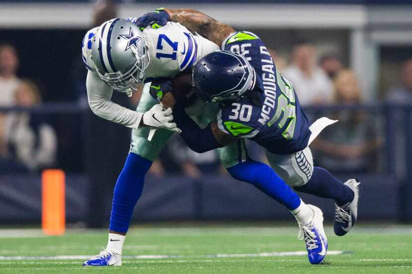 Dallas Cowboys wide receiver Allen Hurns (17) is tackled by Seattle Seahawks strong safety...