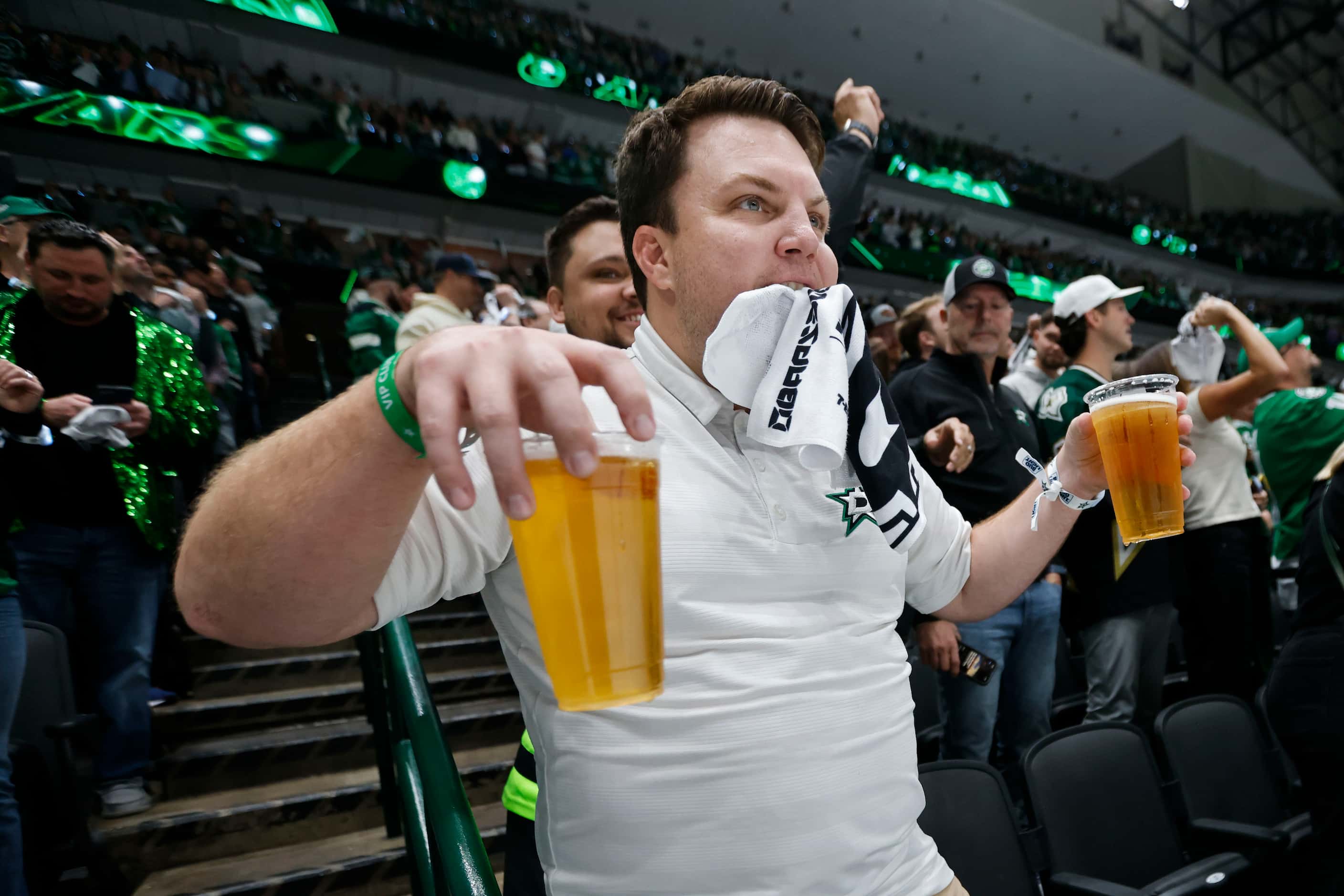 A Dallas Stars fan dance with drinks on his hand following team’s fourth goal during the...