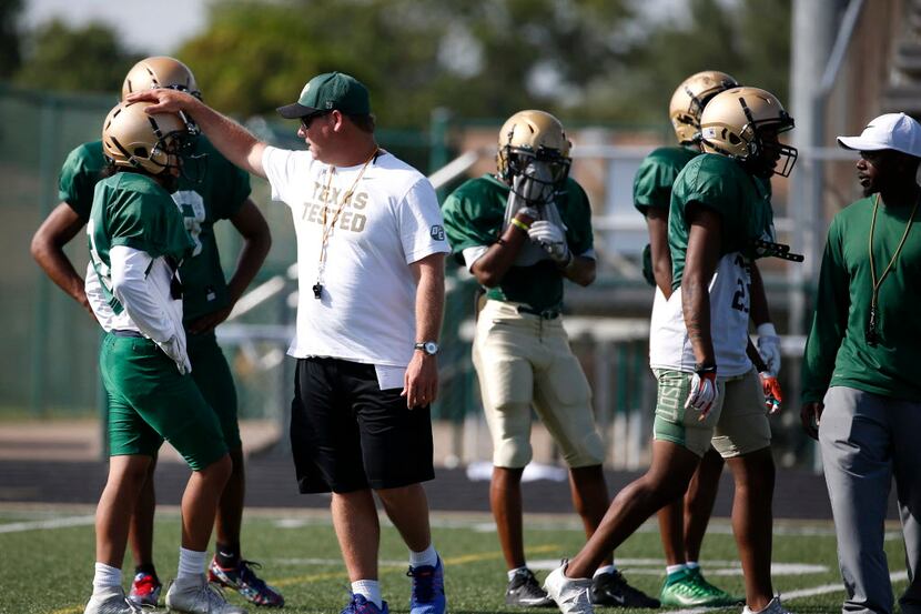 DeSoto head football coach Todd Peterman coaches players during spring practice at Eagle...