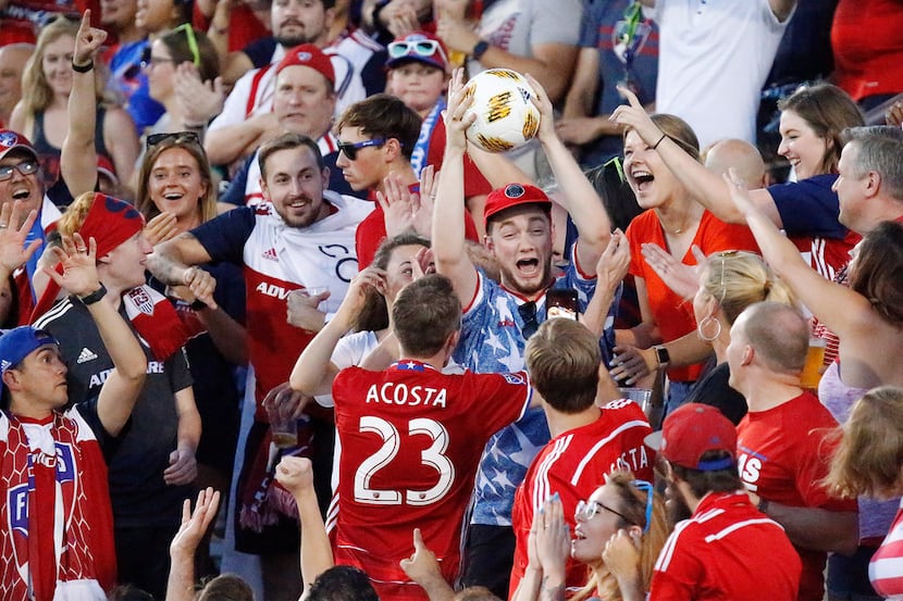 An FC Dallas fan catches a stray shot attempt during the first half as FC Dallas hosted...