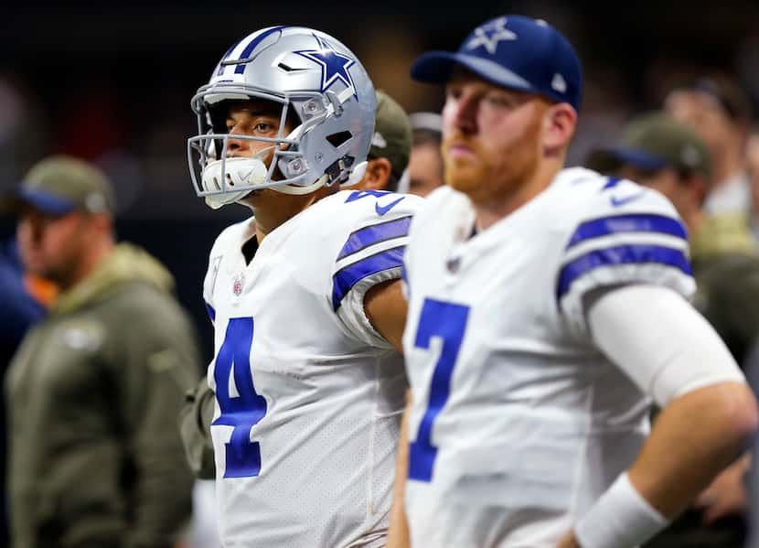 FILE - Cowboys quarterbacks Dak Prescott (4) and Cooper Rush (7) watch the Atlanta Falcons...