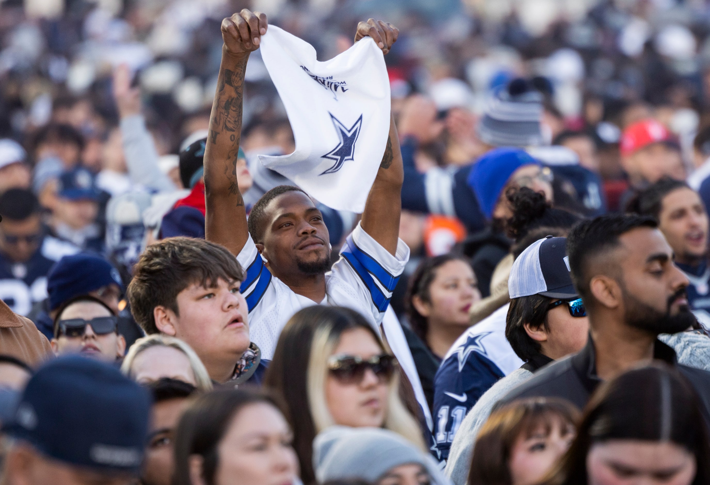 A Dallas Cowboys waves a Cowboys towel as he waits to watch his team take on the San...