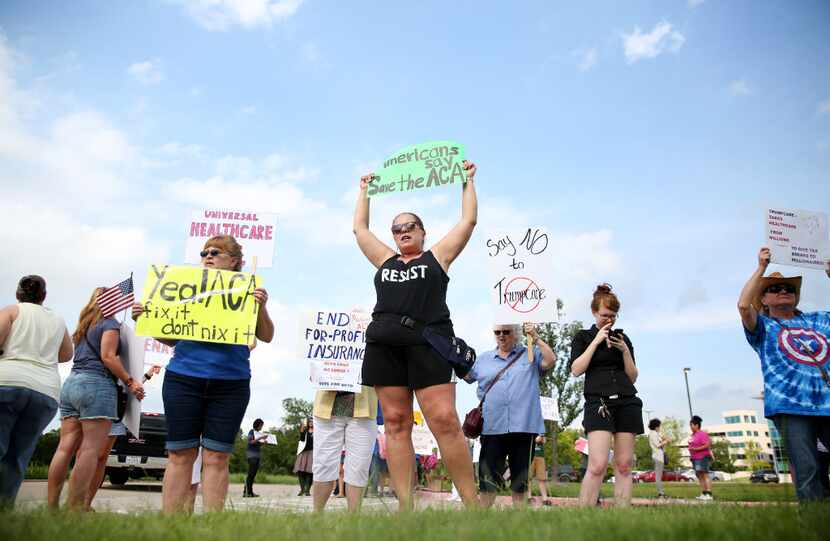 Protesters gather outside the Concerned Veterans of America Defend and Reform Town Hall...