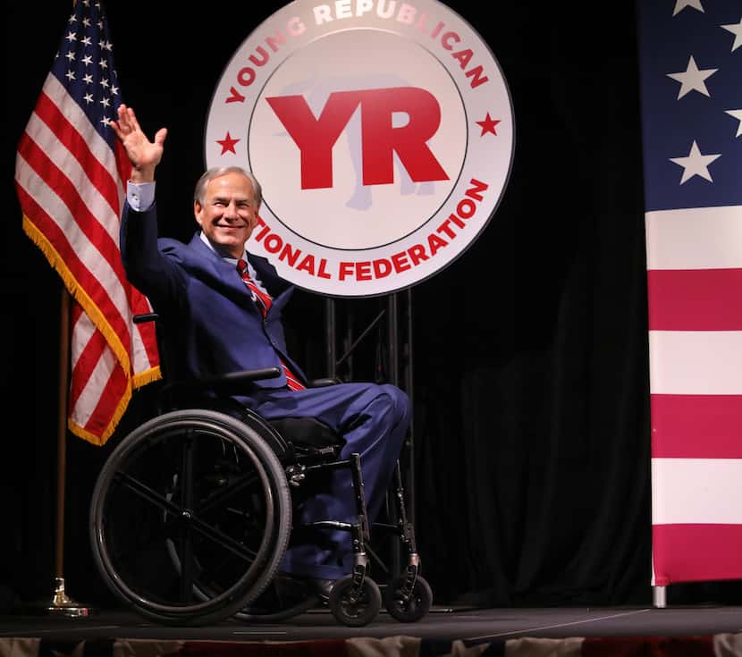 Governor Greg Abbott greets the audience during the Young Republican National Convention at...