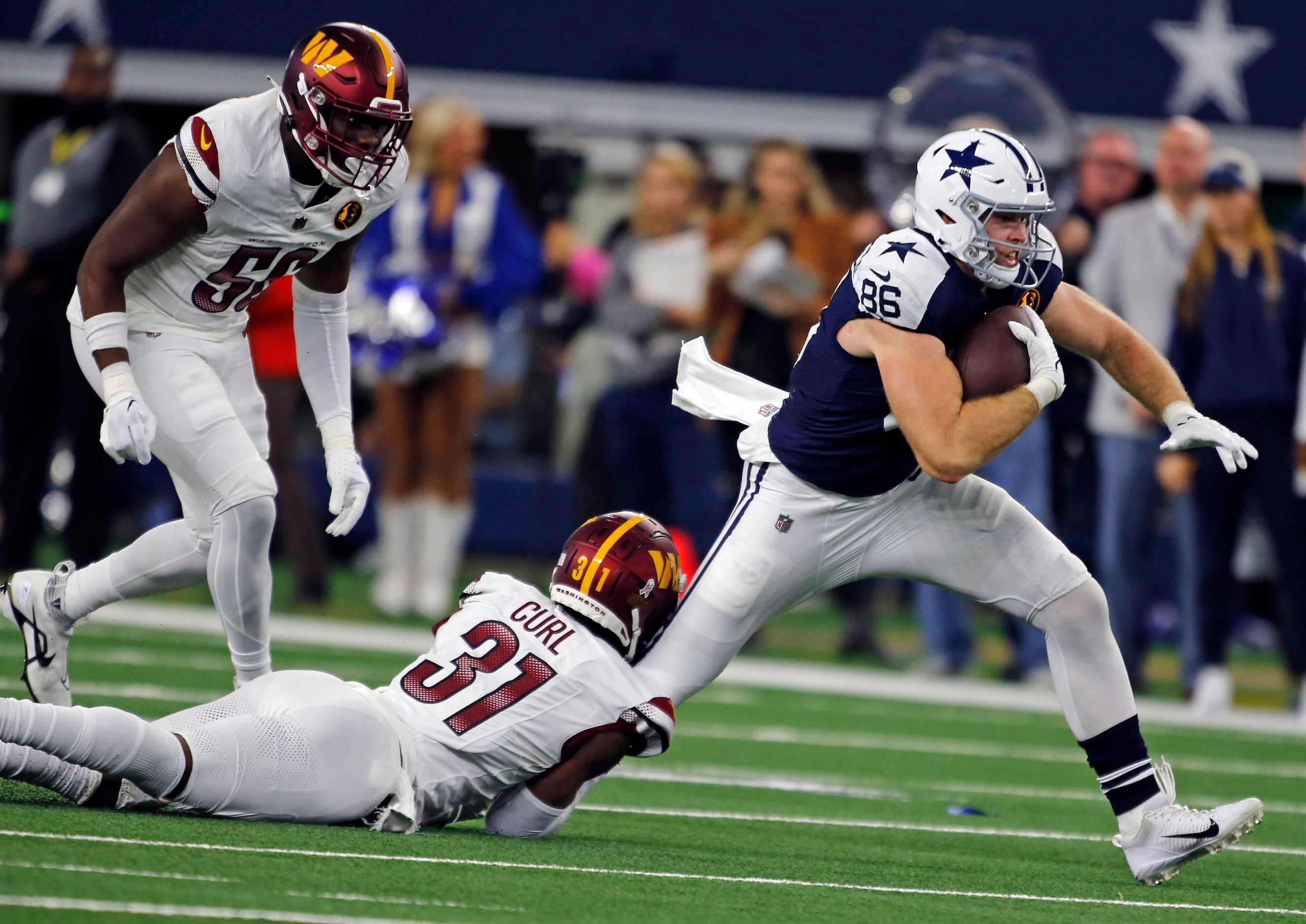 Dallas Cowboys tight end Luke Schoonmaker (86) is tackled by Washington Commanders safety...