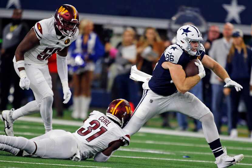 Dallas Cowboys tight end Luke Schoonmaker (86) is tackled by Washington Commanders safety...