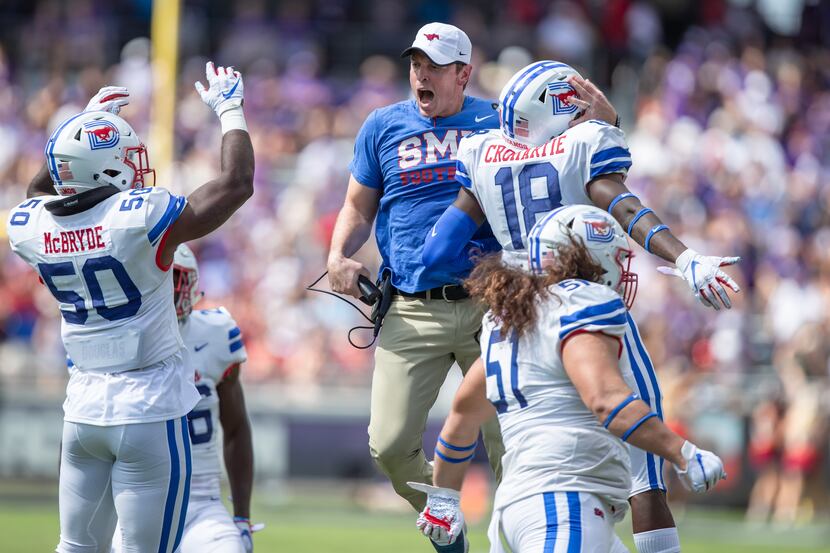FILE - SMU defensive coordinator Kevin Kane celebrates with safety Chace Cromartie (18) and...