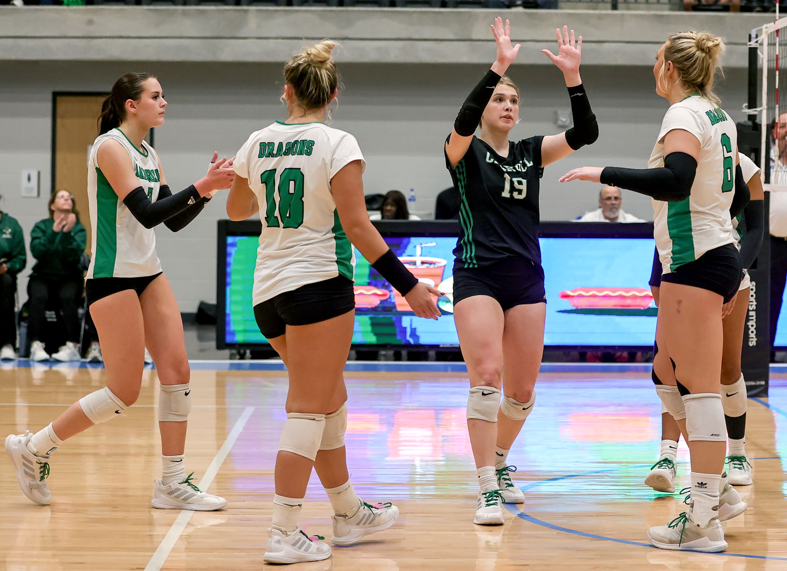 The Southlake Carroll Lady Dragons celebrate a point against Hebron during a Class 6A...