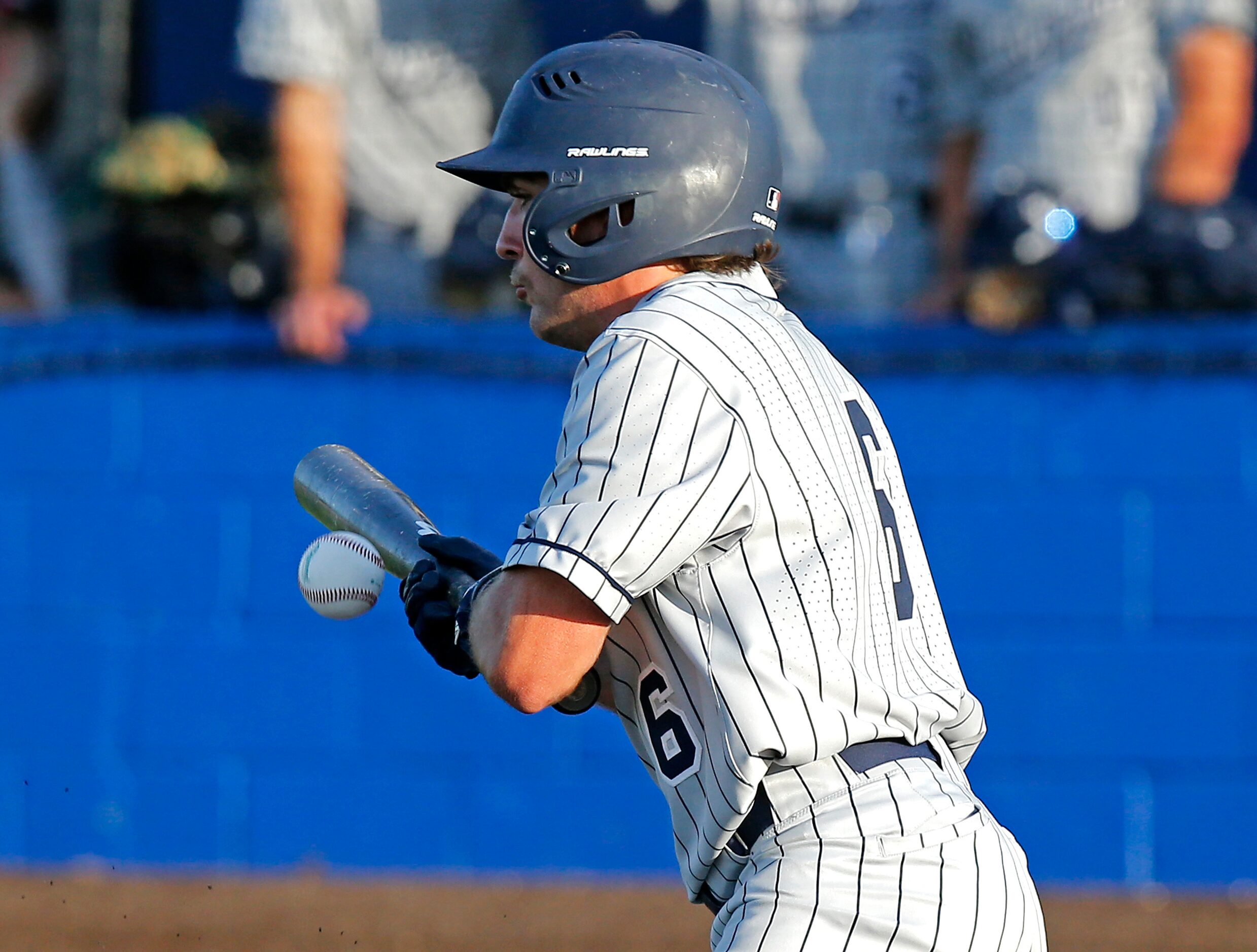 Lone Star High School infielder Owen Peck (6) places a bunt in the first inning as Lone Star...