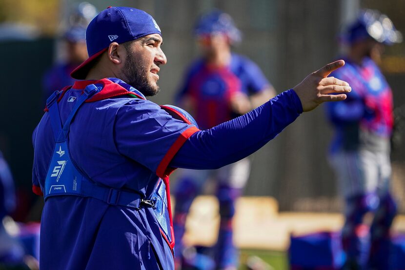 Texas Rangers catcher Jose Trevino works in the bullpen during a training workout at the...