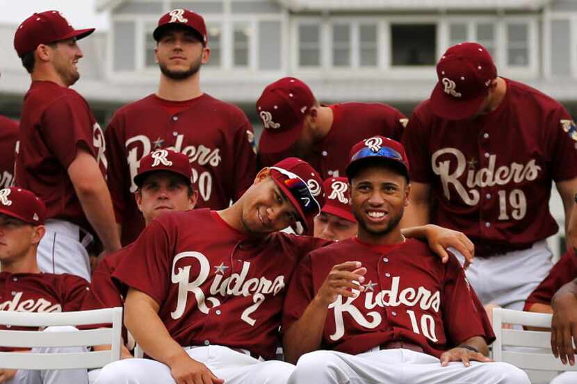 Frisco RoughRiders players Luis Mendez (2) and Chris Garia (10) clown around before having...
