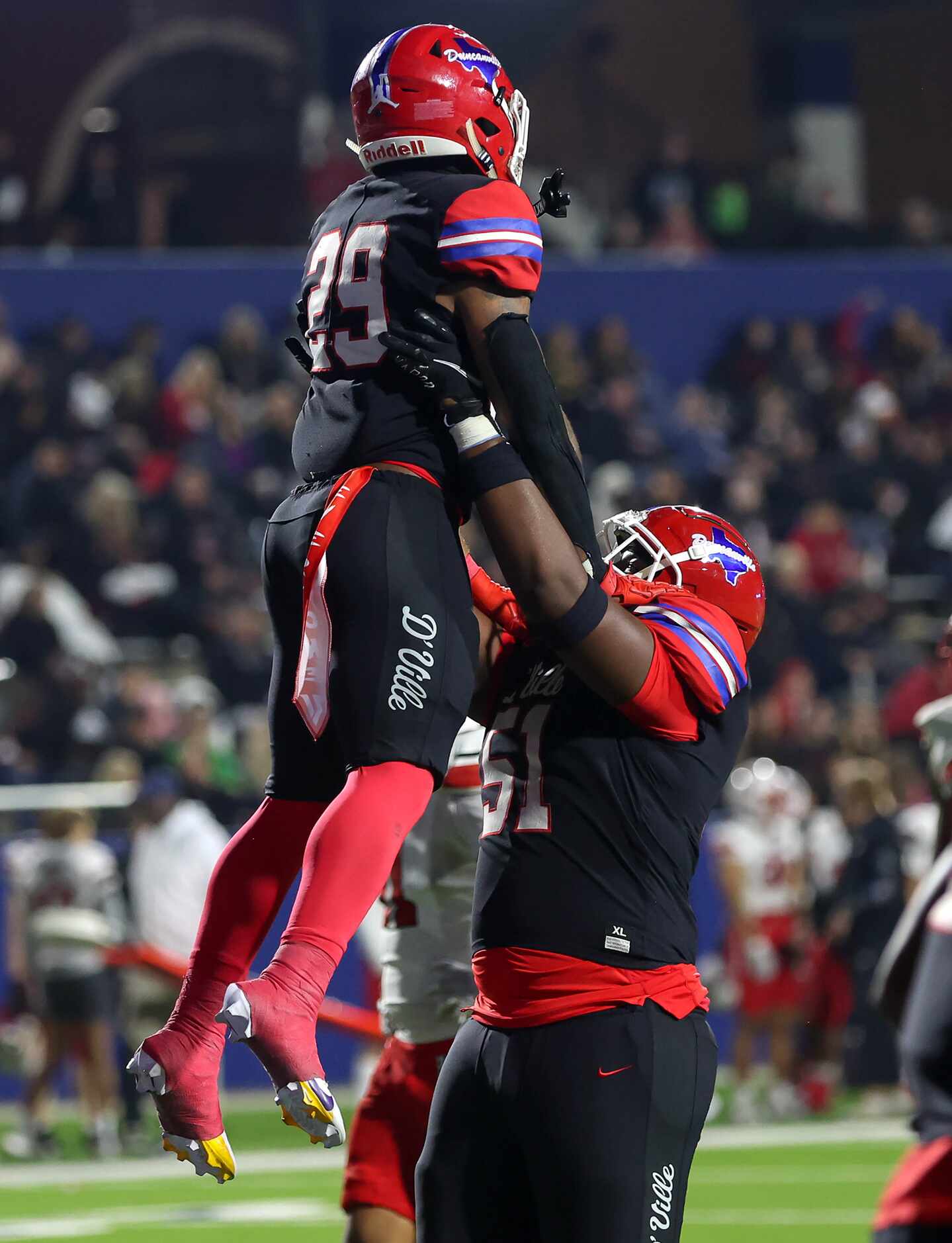 Duncanville running back Caden Durham (29) gets lifted up by offensive lineman Kam Newhouse...