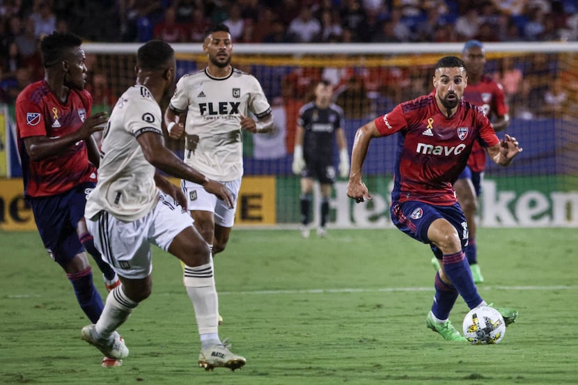 FC Dallas midfielder Sebastian Lletget (12) dribbles the ball up the field during the game...