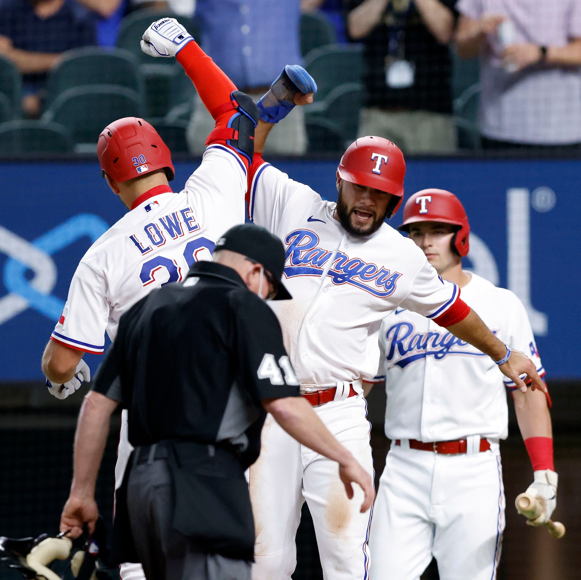 Texas Rangers Nate Lowe (30) is congratulated by teammate Isiah Kiner-Falefa (9) after...