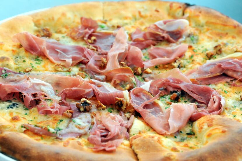 The gorgonzola dolce pizza features prosciutto crudo, caramelized onion, poached pear and...