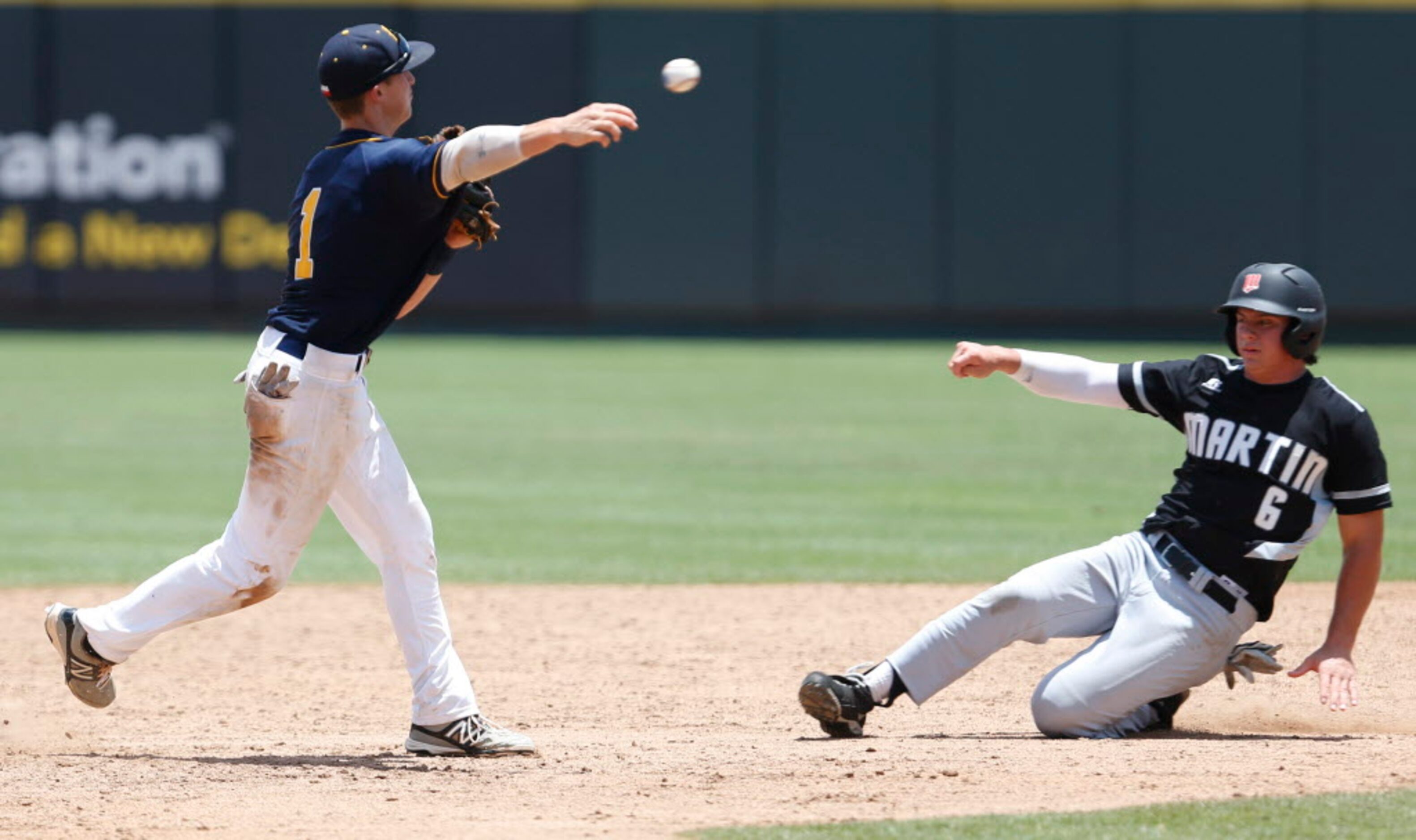 Martin's Josh Watson (6) slides into second base as Cypress Ranch's Masen Hibbeler (1)...