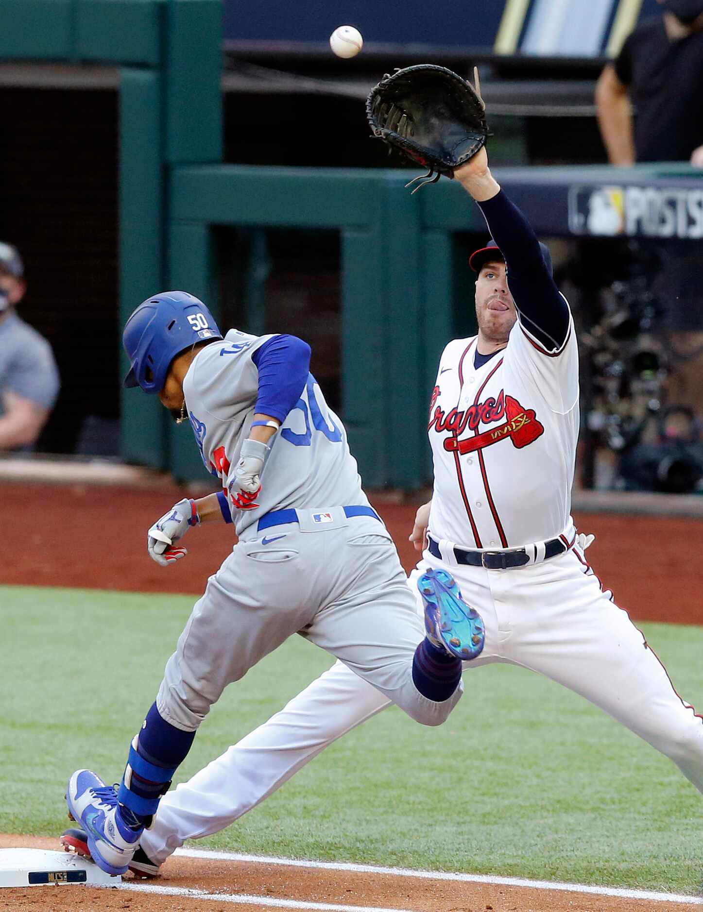 Los Angeles Dodgers batter Mookie Betts (50) is safe at first on the throw to Atlanta Braves...