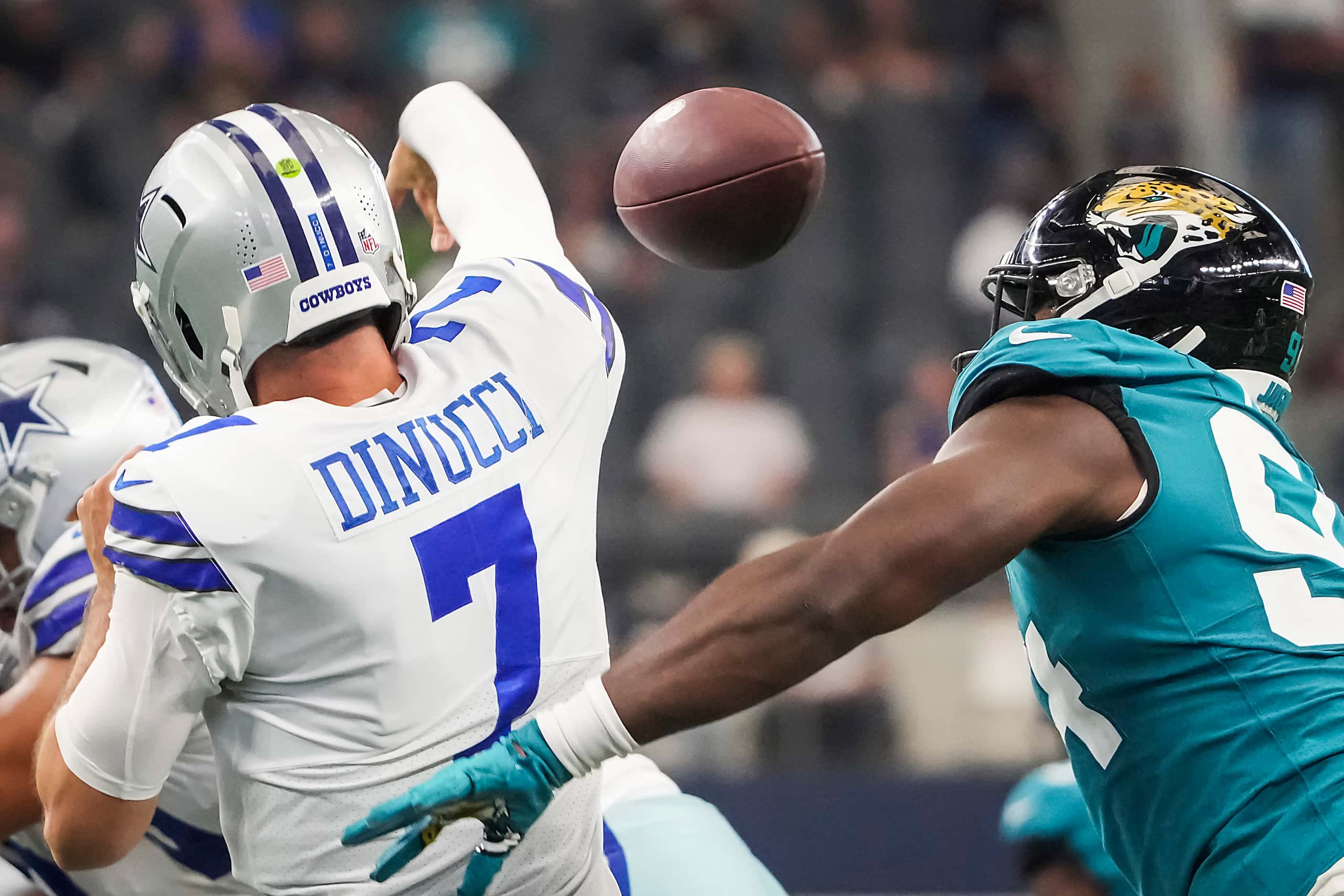 Dallas Cowboys quarterback Ben DiNucci (7) fumbles as he is hit by Jacksonville Jaguars...