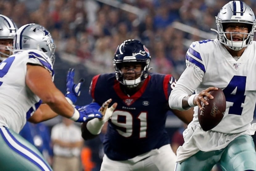 Dallas Cowboys quarterback Dak Prescott (4) scrambles out of the pocket under pressure from...