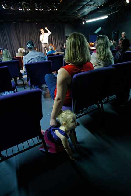 Amy Pramuk holds her child Evey Cordray, 2, as U.S. Congressman Beto O'Rourke makes a speech...