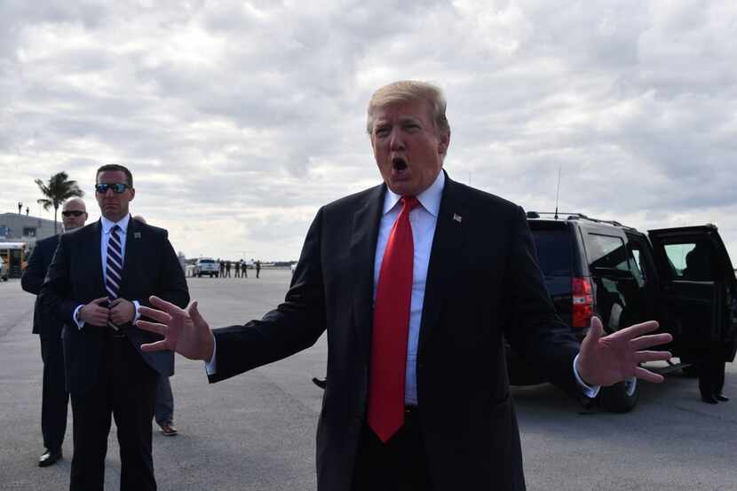 President Donald Trump speaks to reporters at Palm Beach International Airport March 24,...