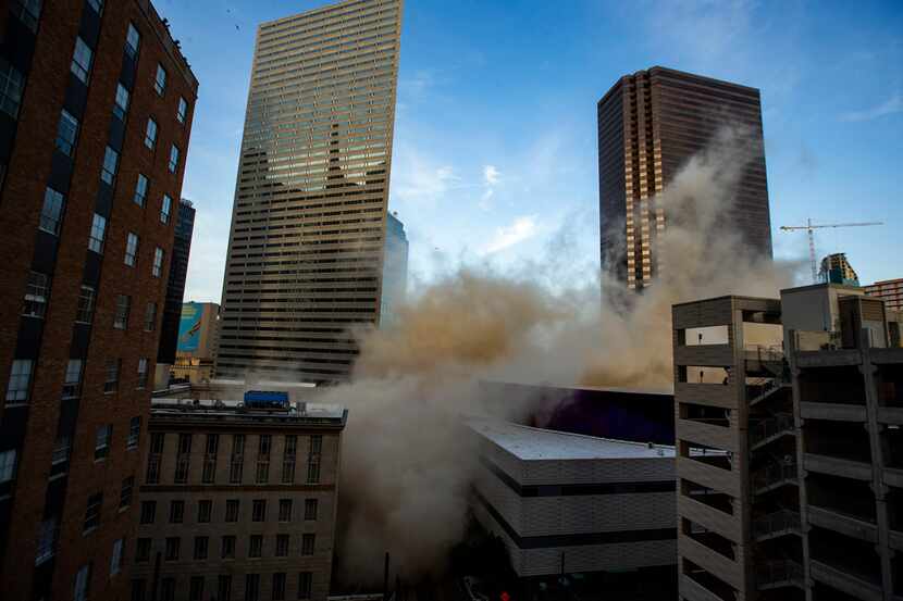People take pictures of a building located at 505 north Ervay St. in downtown Dallas as it...