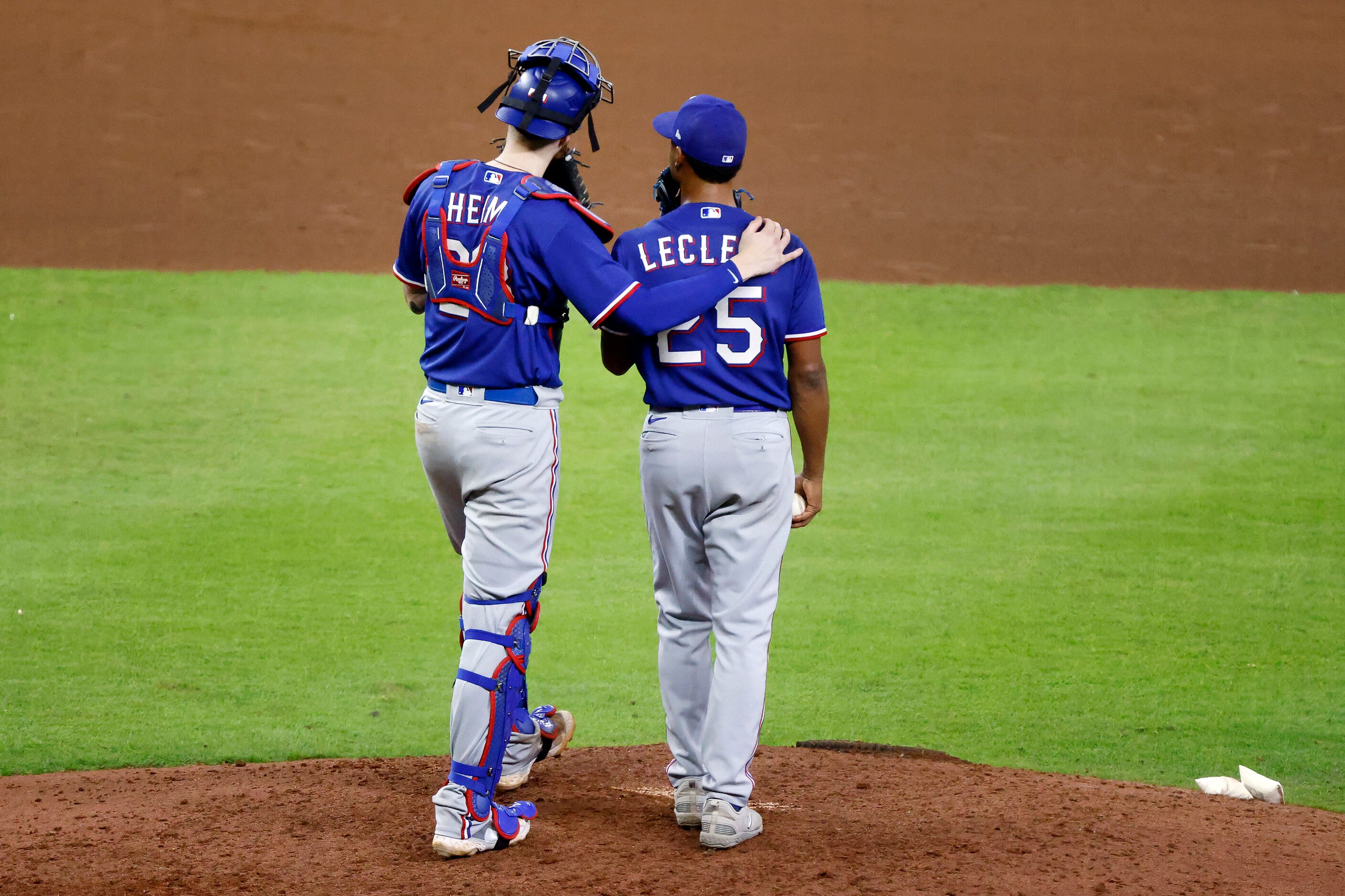 Texas Rangers catcher Jonah Heim (28) made a trip to the mound for a word with relief...