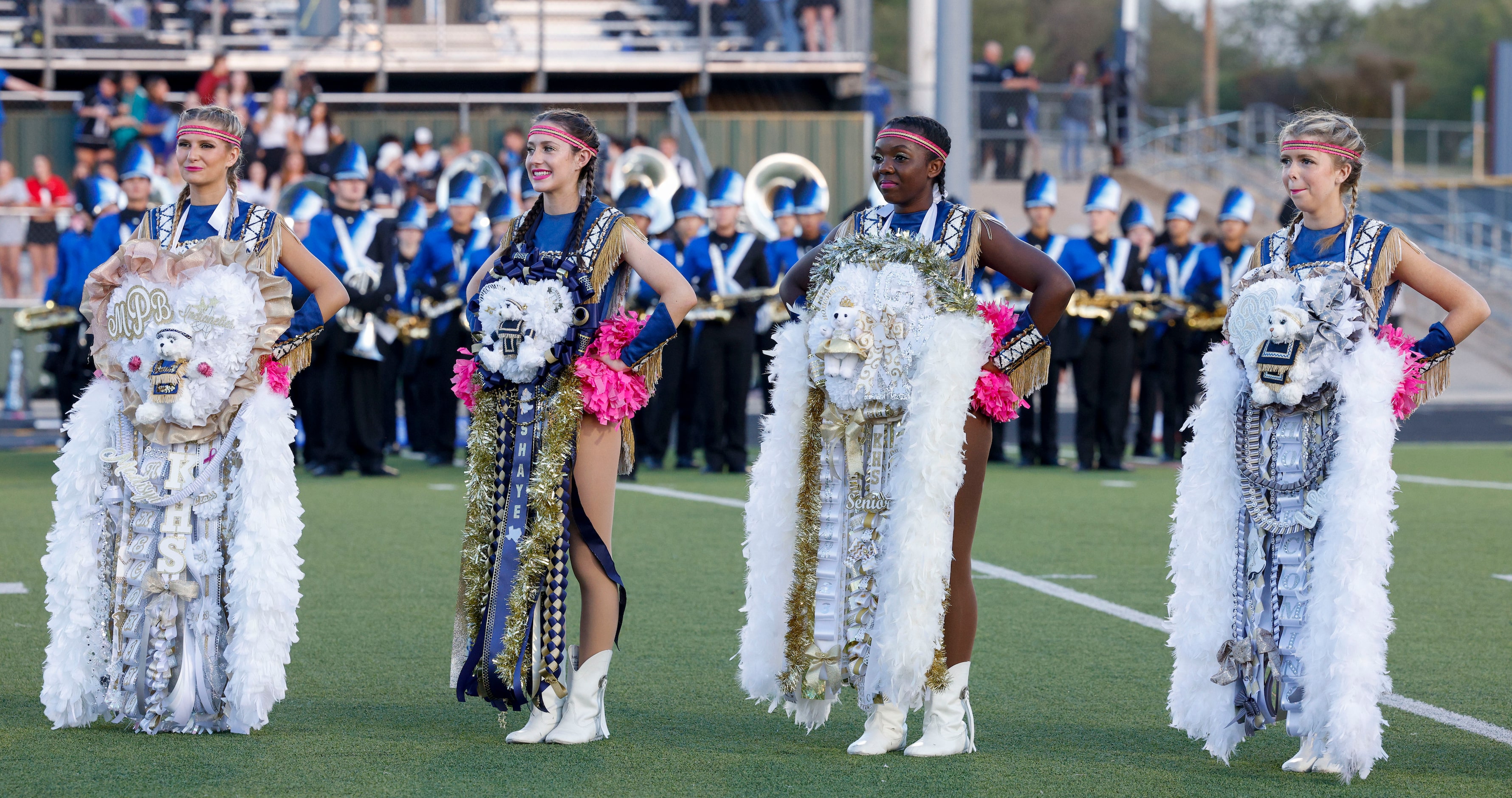 Members of the Keller High School Indianettes wear their homecoming mums before a game...