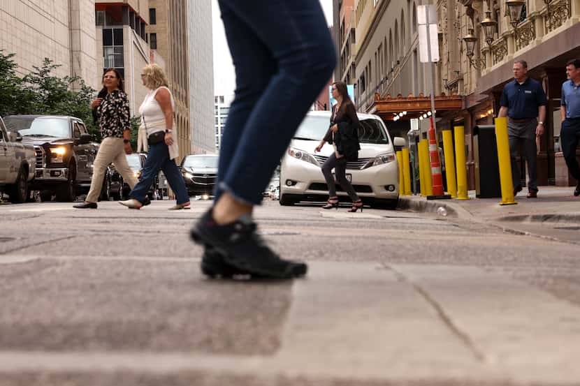 People cross Commerce St. in downtown Dallas on Monday, May 23, 2022, in Dallas. A recent...