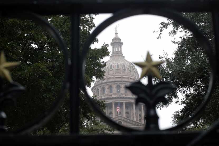 This Dec. 9, 2013 file photo shows the Texas  Capitol through the south gate in Austin....