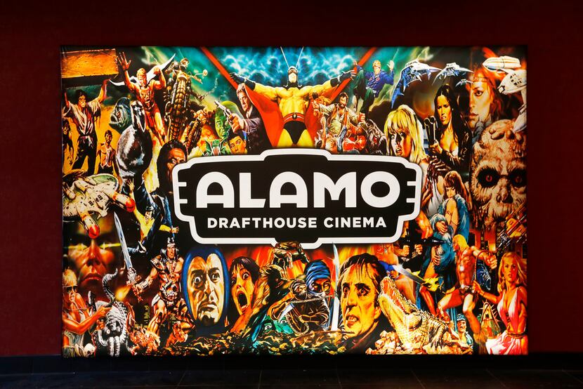 A light-up sign in the lobby of the new Alamo Drafthouse in Lake Highlands shows the current...
