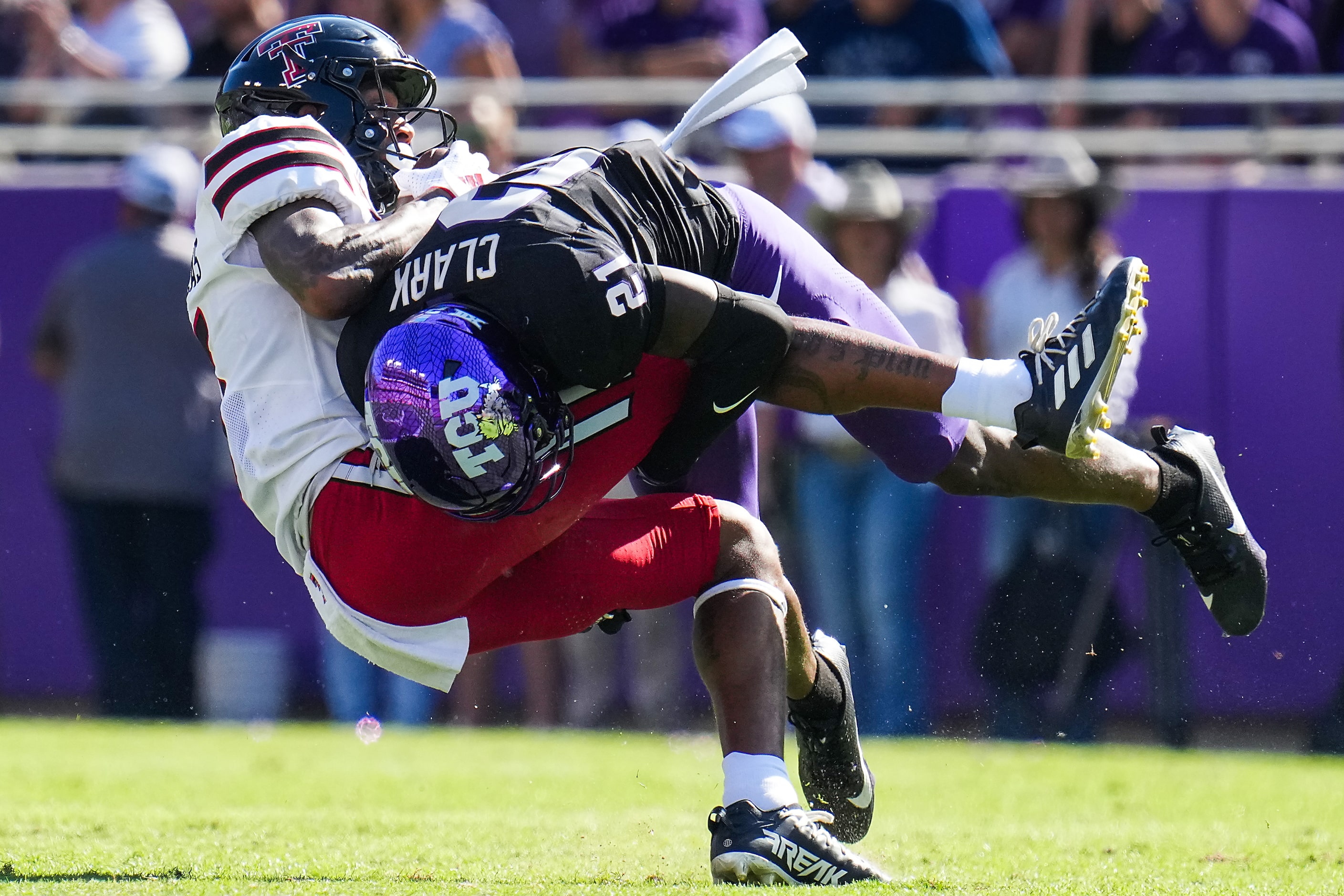 Texas Tech wide receiver Caleb Douglas (5) is brought down by TCU safety Bud Clark (21)...