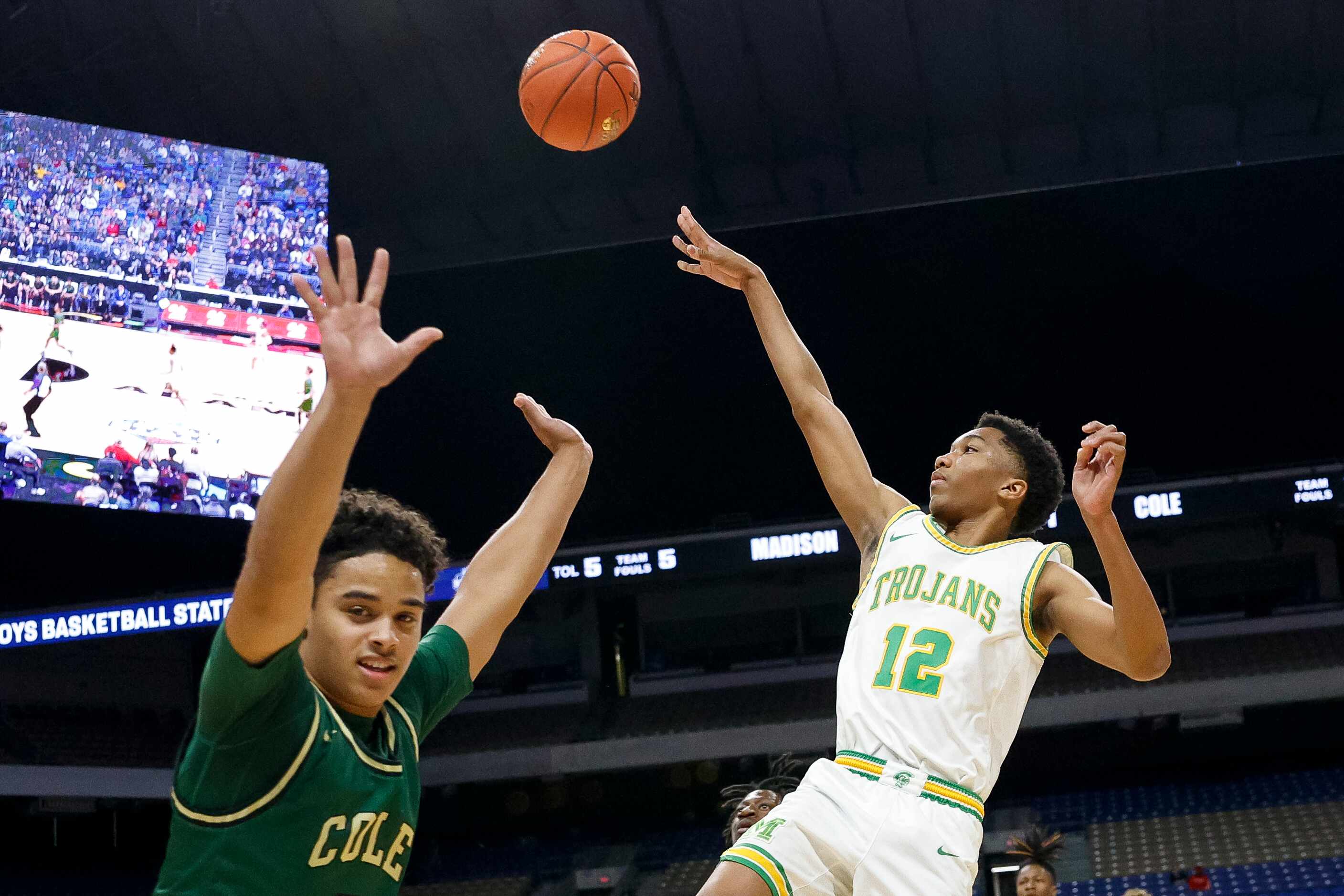 Madison guard Brandon Patterson (12) floats a shot over Mansfield Timberview guard Braylon...