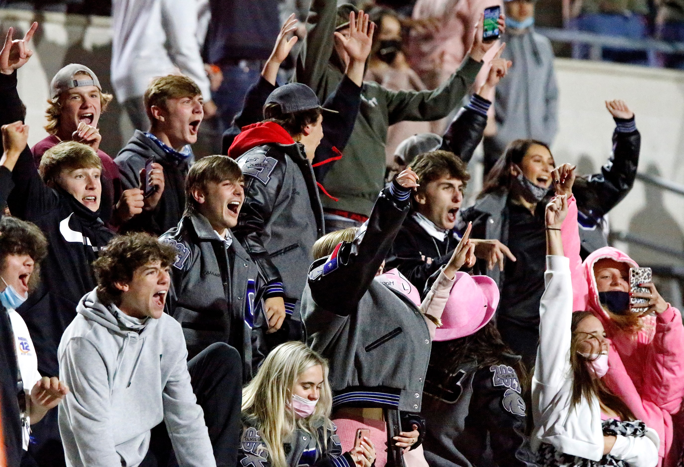 Fans in the Denton Guyer student section react as the wining extra point goes through the...