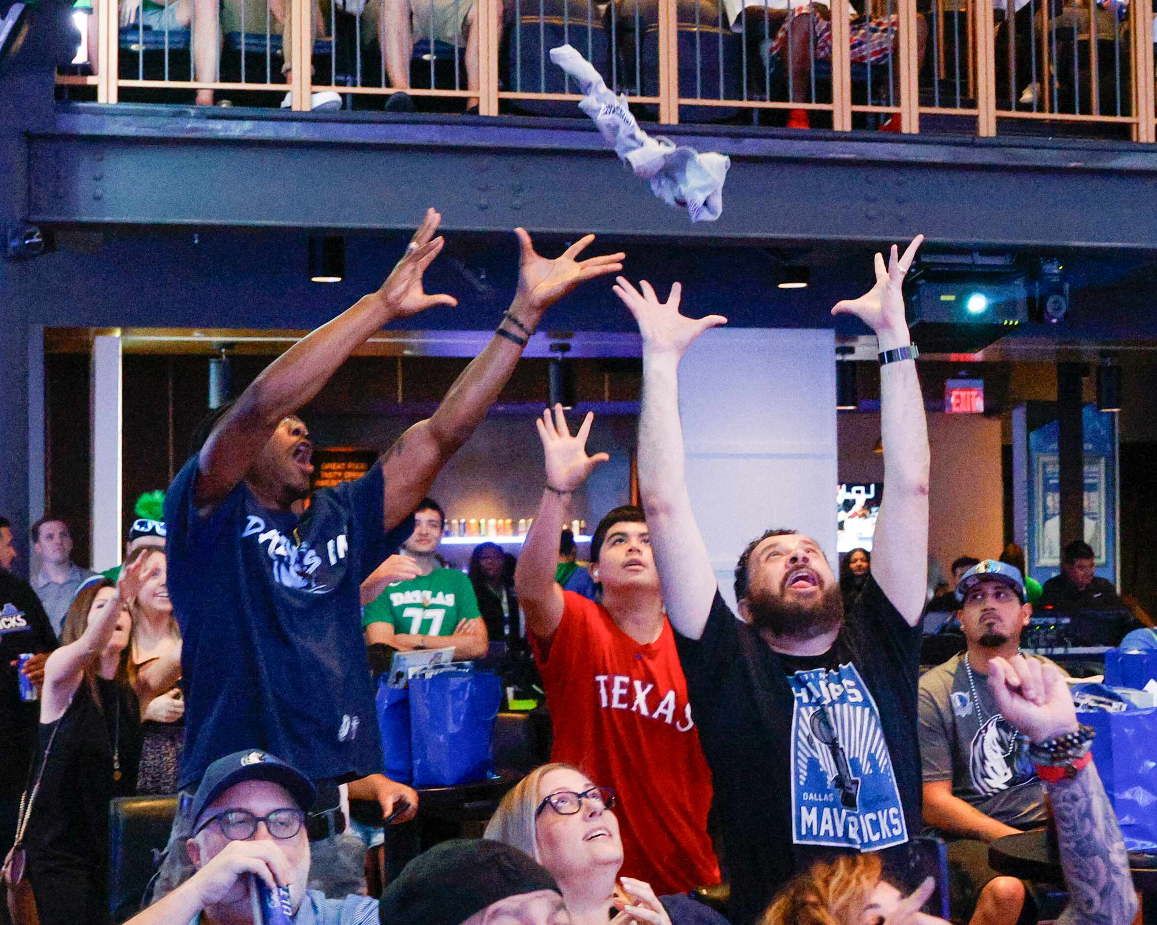 Dallas Mavericks fans reach for a shirt during a 2023 NBA Draft watch party at The Echo...