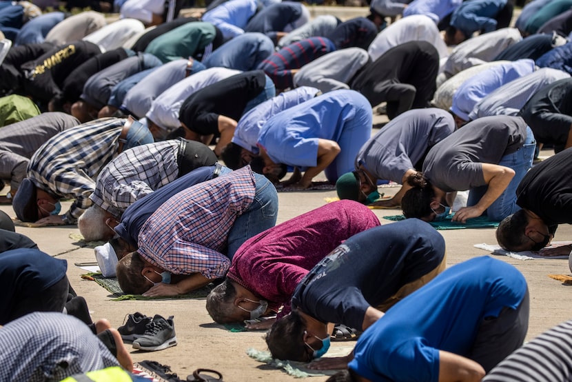 Mourners pray at the services Thursday at the Islamic Association of Allen for the family of...