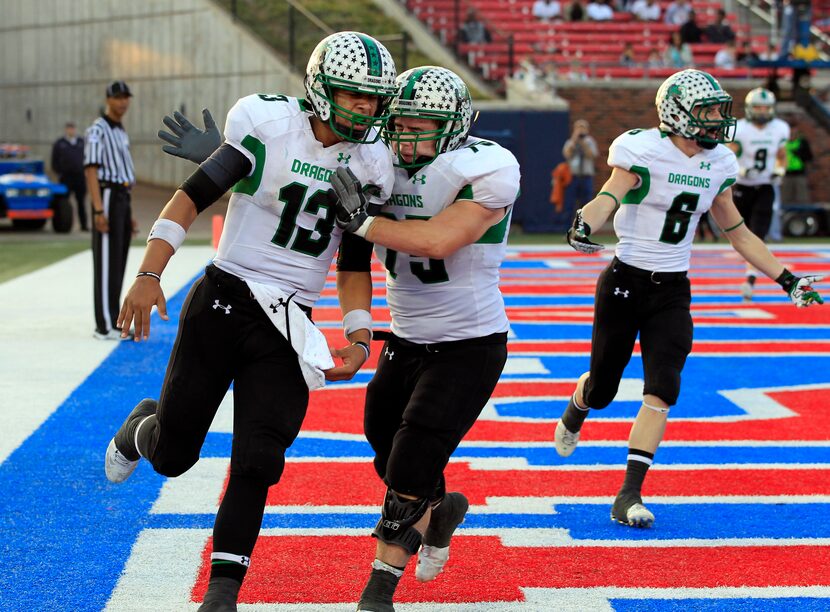 Southlake Carroll QB Kenny Hill (13) gets a pat on the back by offensive lineman Holden...