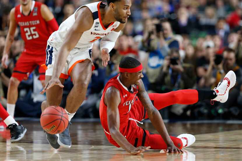 Texas Tech Red Raiders forward Tariq Owens (11) falls after going after a loose ball as...