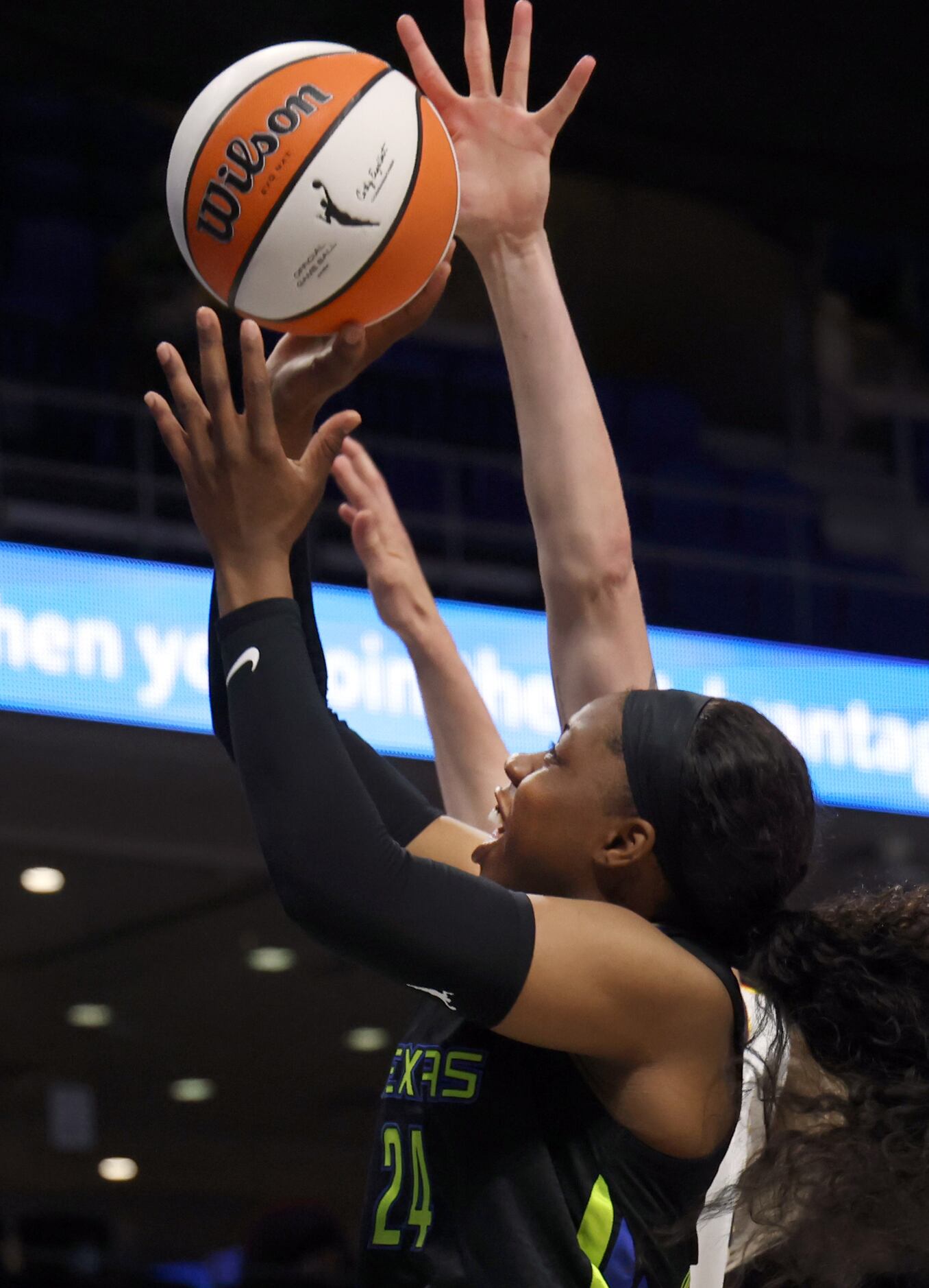 Dallas Wings guard Arike Ogunbowale (24) shoots over an Indiana Fever defender during the...
