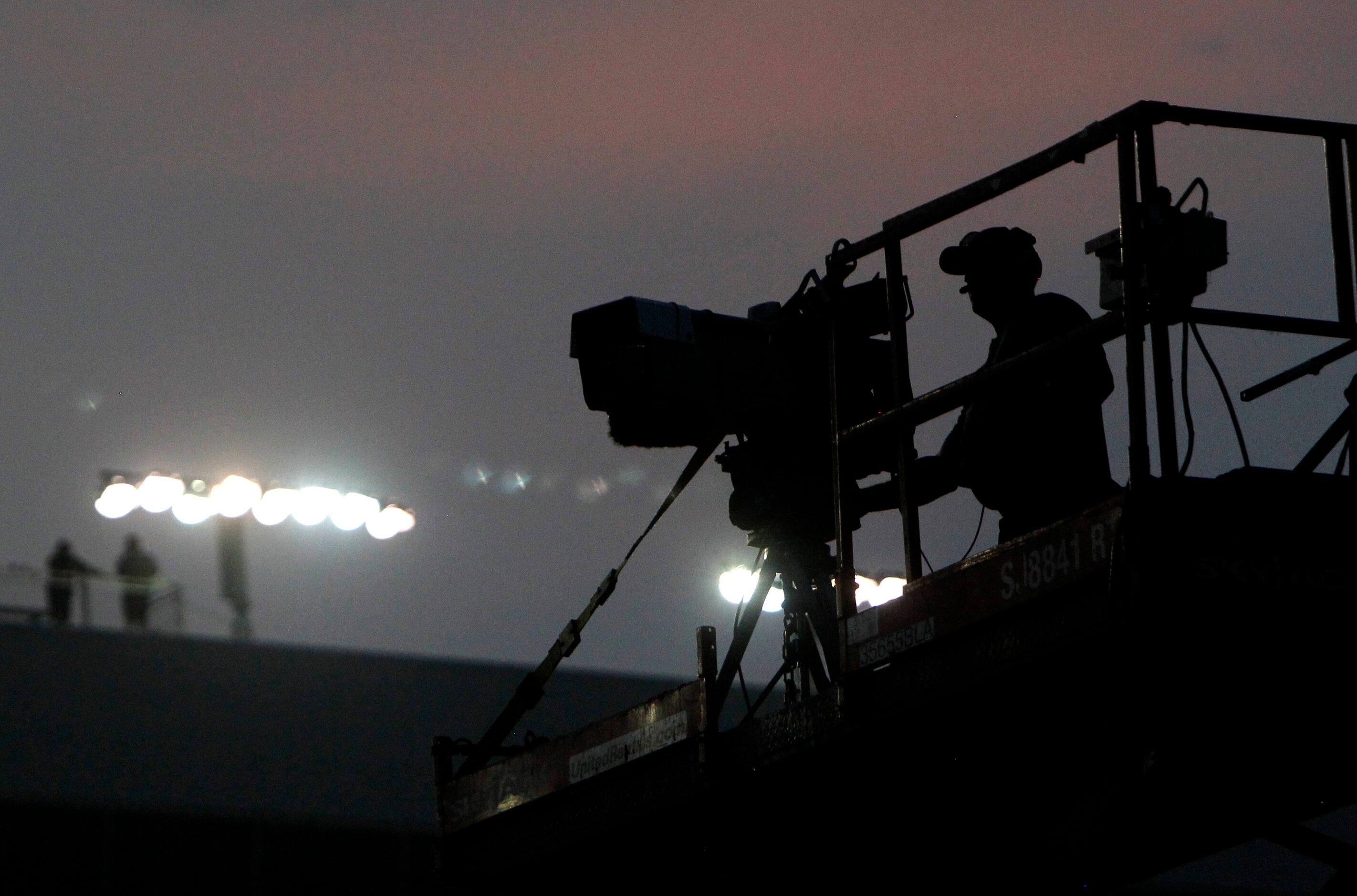 A photographer video records the second half of the race from an elevated platform. The...