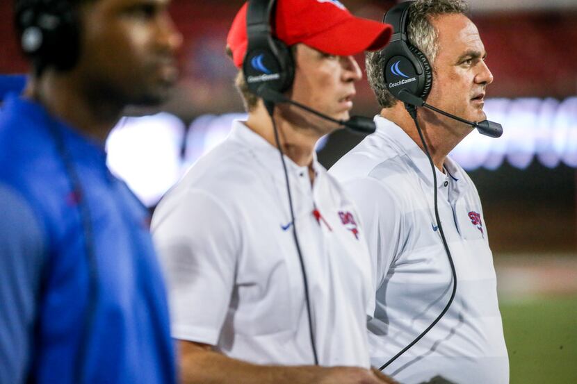 Southern Methodist Mustangs head coach Sonny Dykes looks on along with his coaching staff...