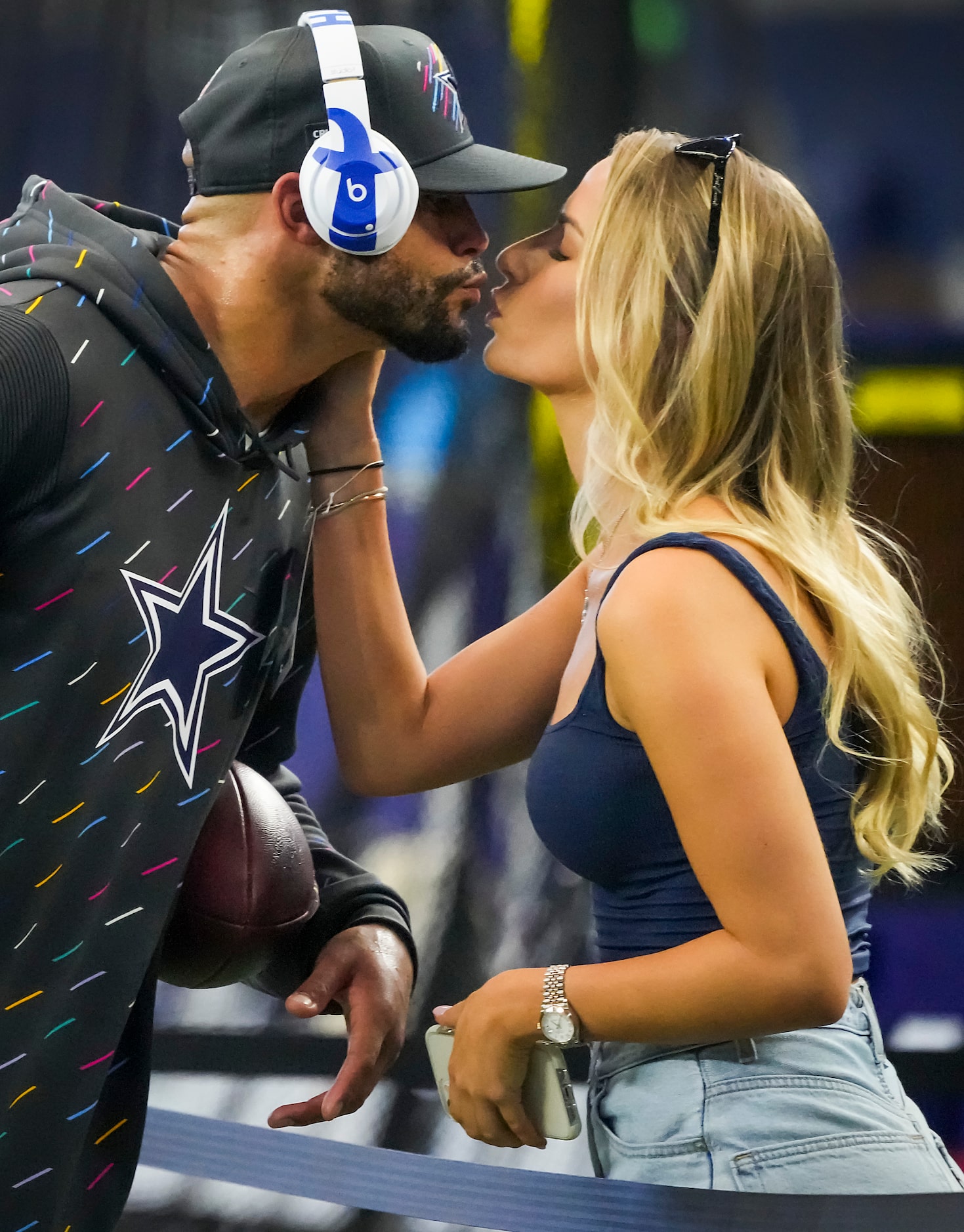 Dallas Cowboys quarterback Dak Prescott kisses his girlfriend Natalie Buffett on the...