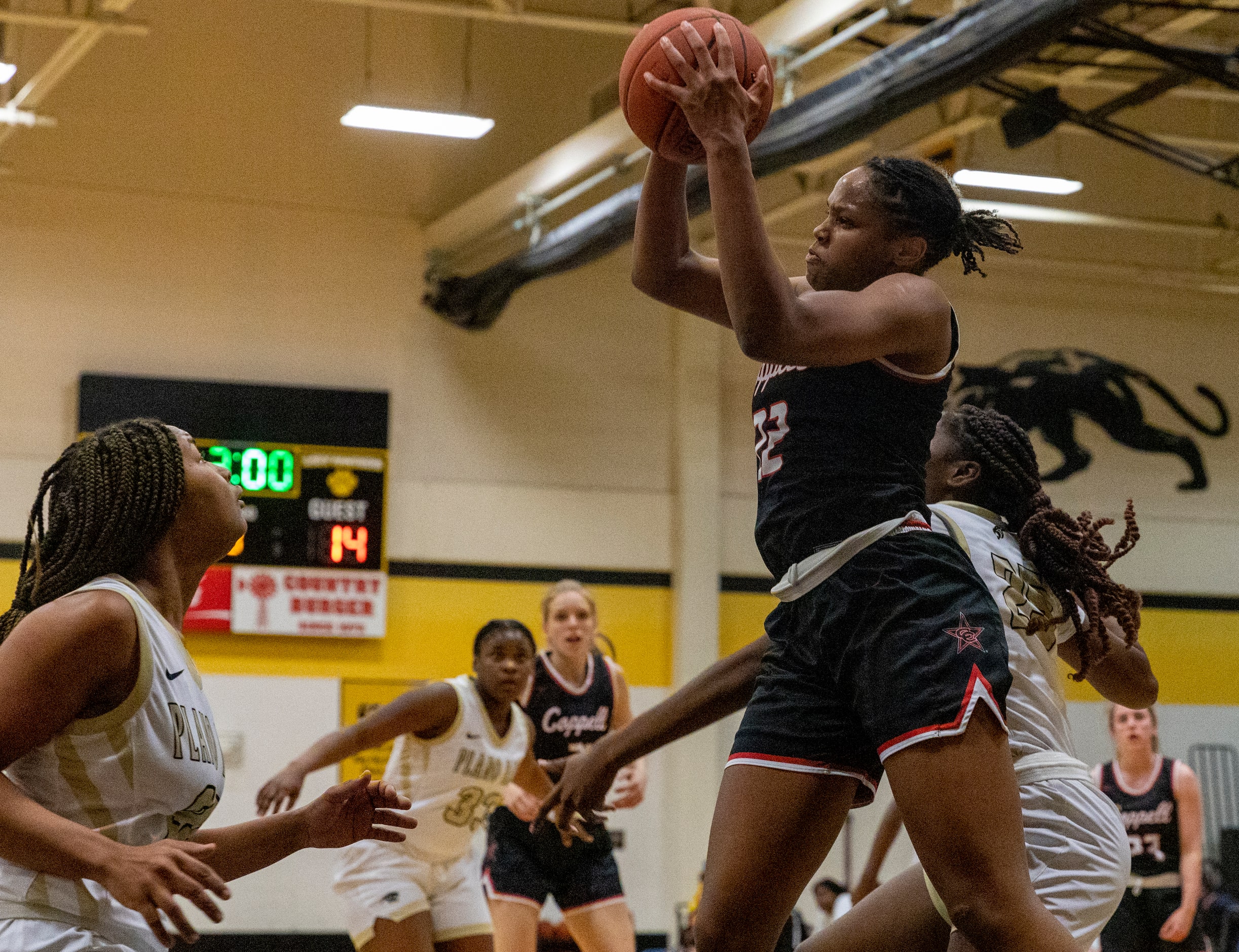 Coppell High School India Howard (22) jumps to shoot the ball during the second half of the...