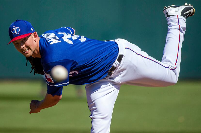 Texas Rangers pitcher Mike Minor pitches during the first inning a spring training baseball...