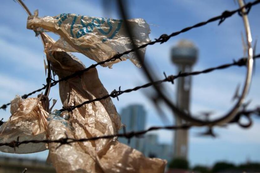 
An old grocery bag blows while stuck to a fence along South Riverfront Boulevard in Dallas.
